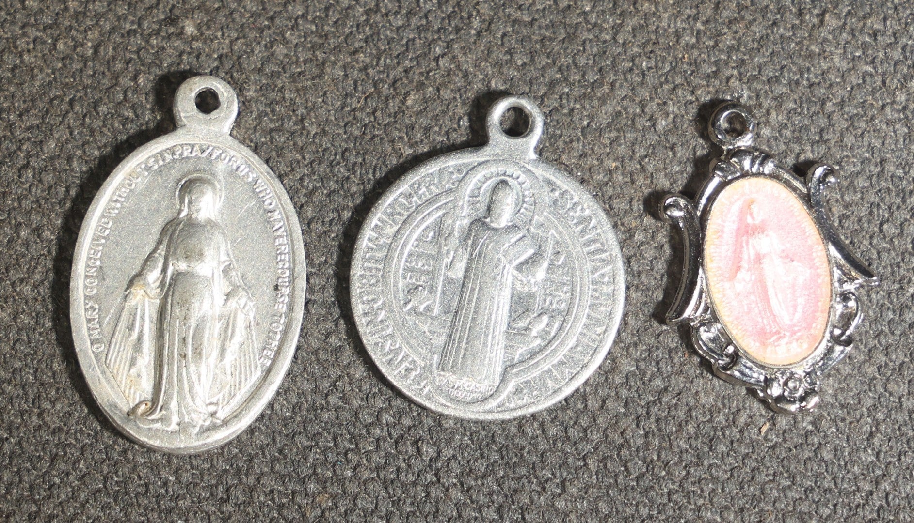 Grouping of 11 Antique and Vintage Religious Medals including Four Sterling Silver Examples with Various Saints, Miraculous Medal, Sacred Heart, and Crucifix Motifs