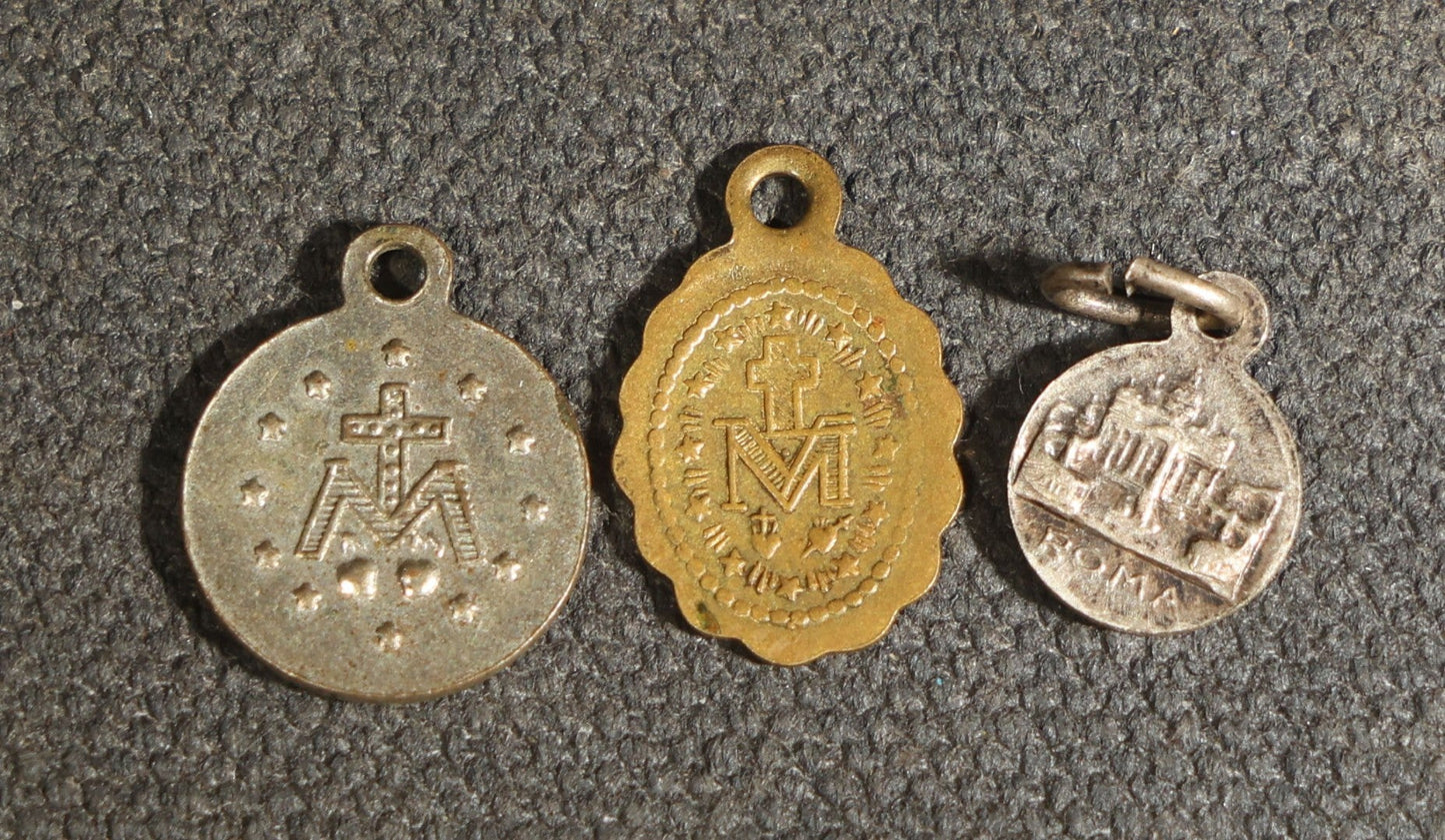 Grouping of 11 Antique and Vintage Religious Medals including Four Sterling Silver Examples with Various Saints, Miraculous Medal, Sacred Heart, and Crucifix Motifs