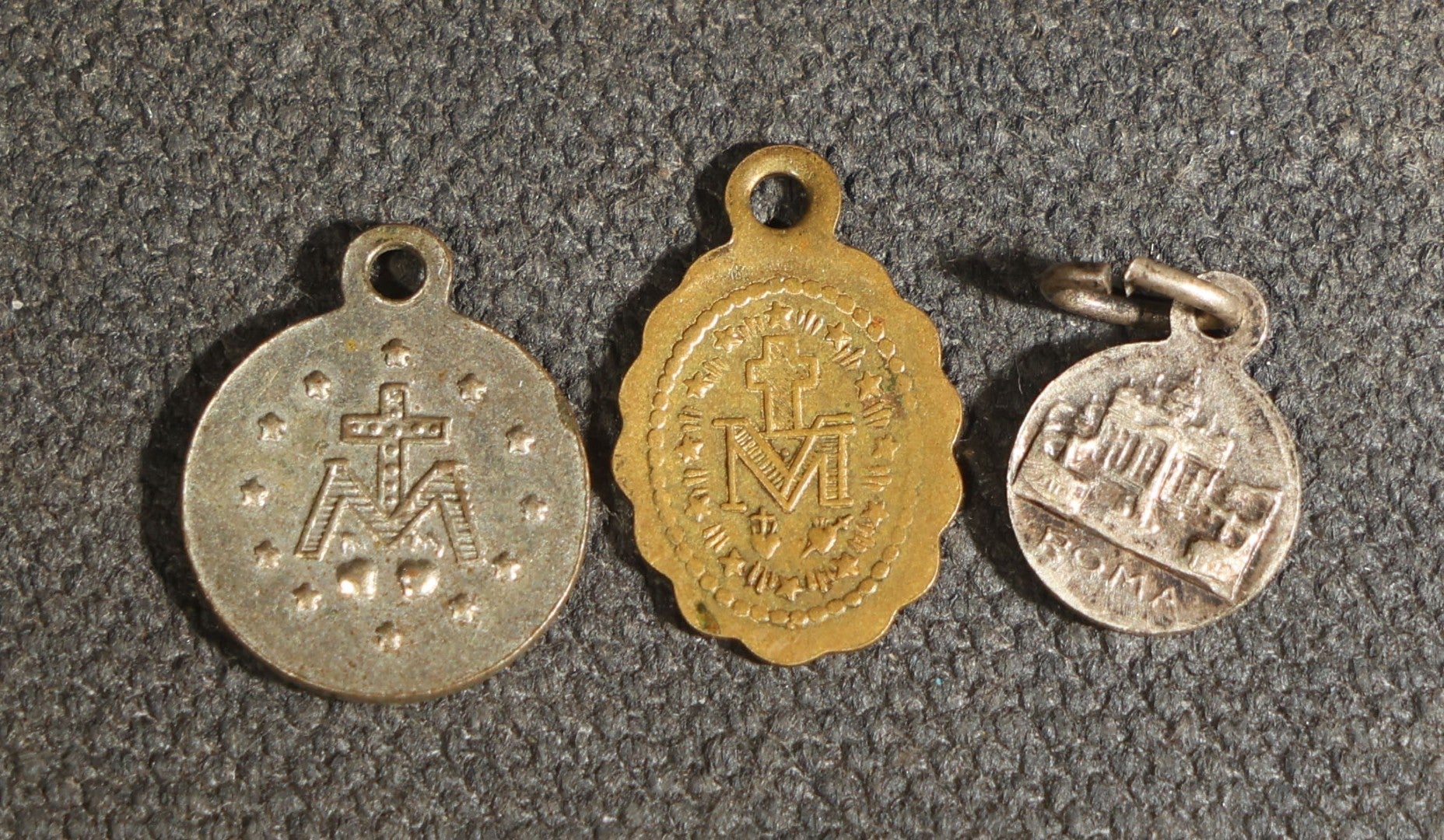 Grouping of 11 Antique and Vintage Religious Medals including Four Sterling Silver Examples with Various Saints, Miraculous Medal, Sacred Heart, and Crucifix Motifs