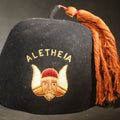Lot 091 - Vintage Black Felt Aletheia Fraternal Fez with Winged Viking Head Emblem and Orange Tassel, Charles F. Olpp Jeweler, New York, 7" H