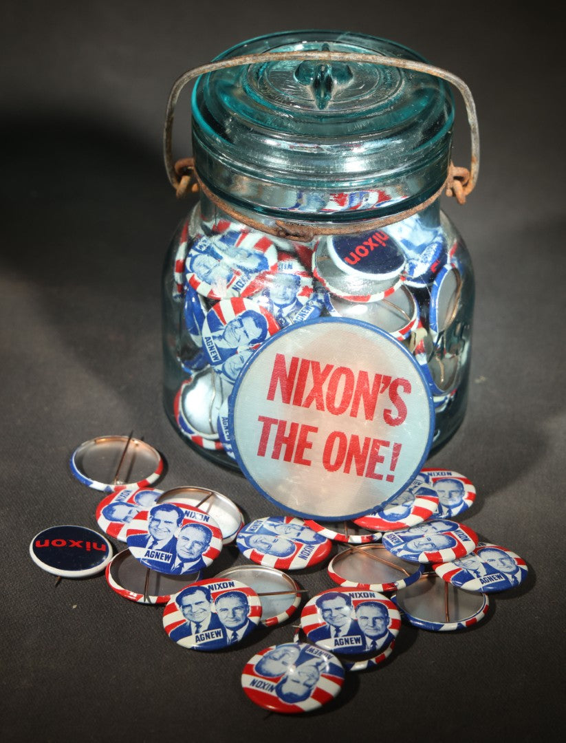 Grouping of Vintage Political Campaign Buttons and Pins including Nixon/Agnew, Johnson, Jimmy Carter Peanut Pins, and Lenticular "Nixon's the One!" Button in Wire Bail Glass Storage Jar