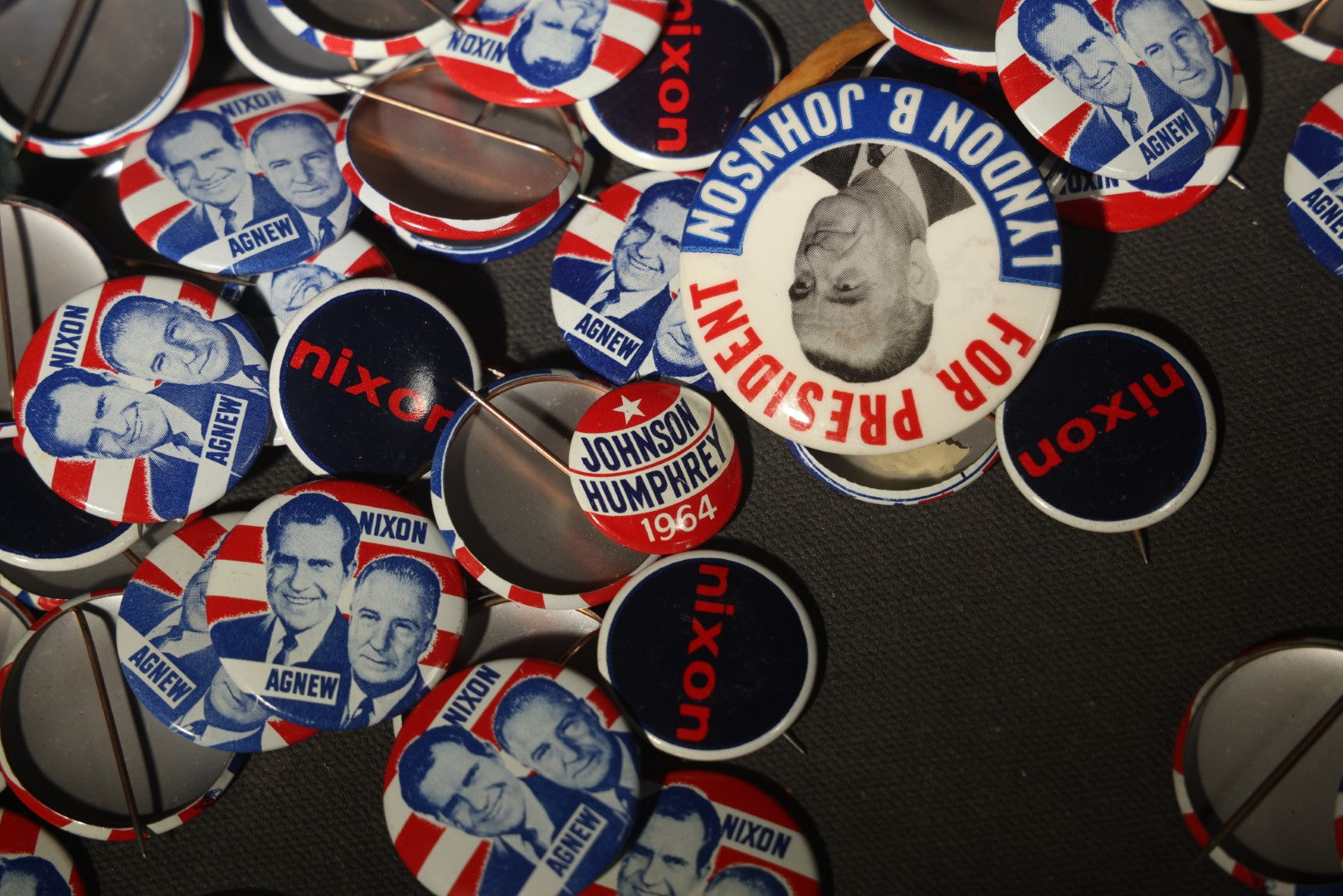 Grouping of Vintage Political Campaign Buttons and Pins including Nixon/Agnew, Johnson, Jimmy Carter Peanut Pins, and Lenticular "Nixon's the One!" Button in Wire Bail Glass Storage Jar