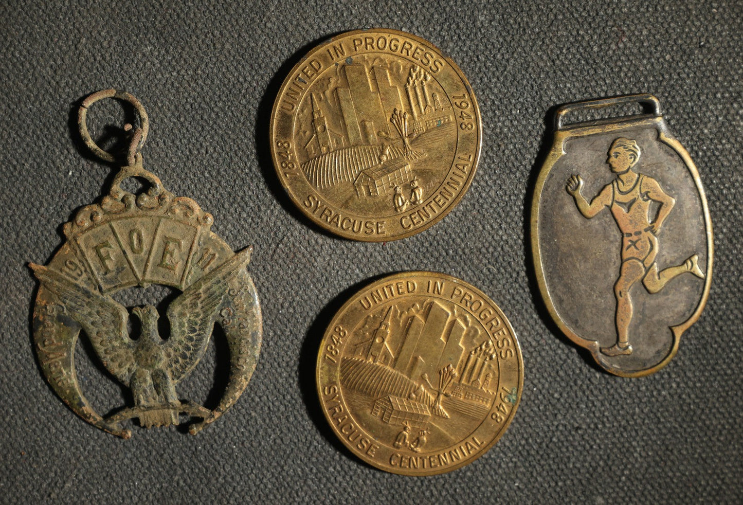 Four Pieces Including Federal Order of Eagles and Track Fobs, and Pair of Syracuse New York Centennial Coins