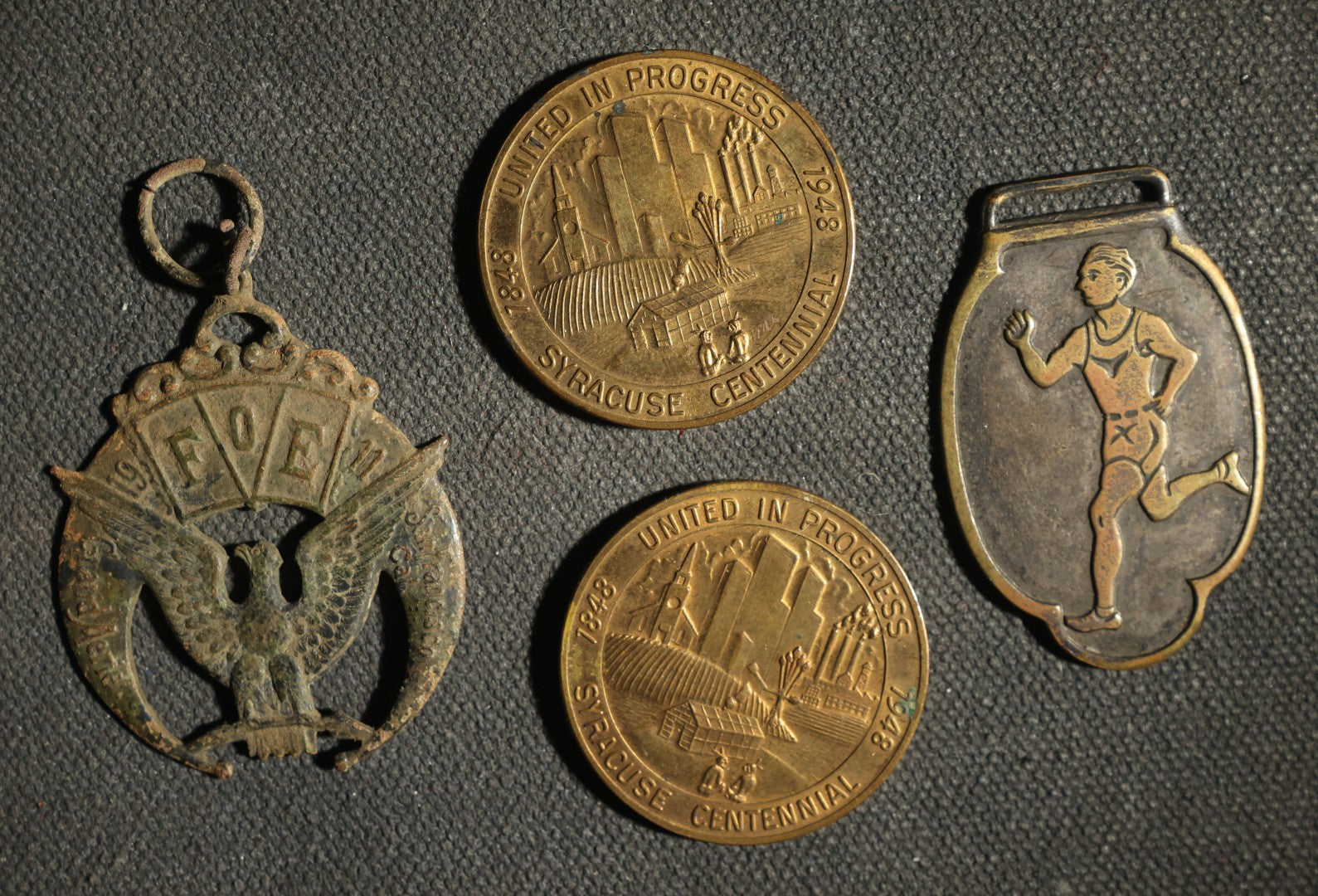 Four Pieces Including Federal Order of Eagles and Track Fobs, and Pair of Syracuse New York Centennial Coins