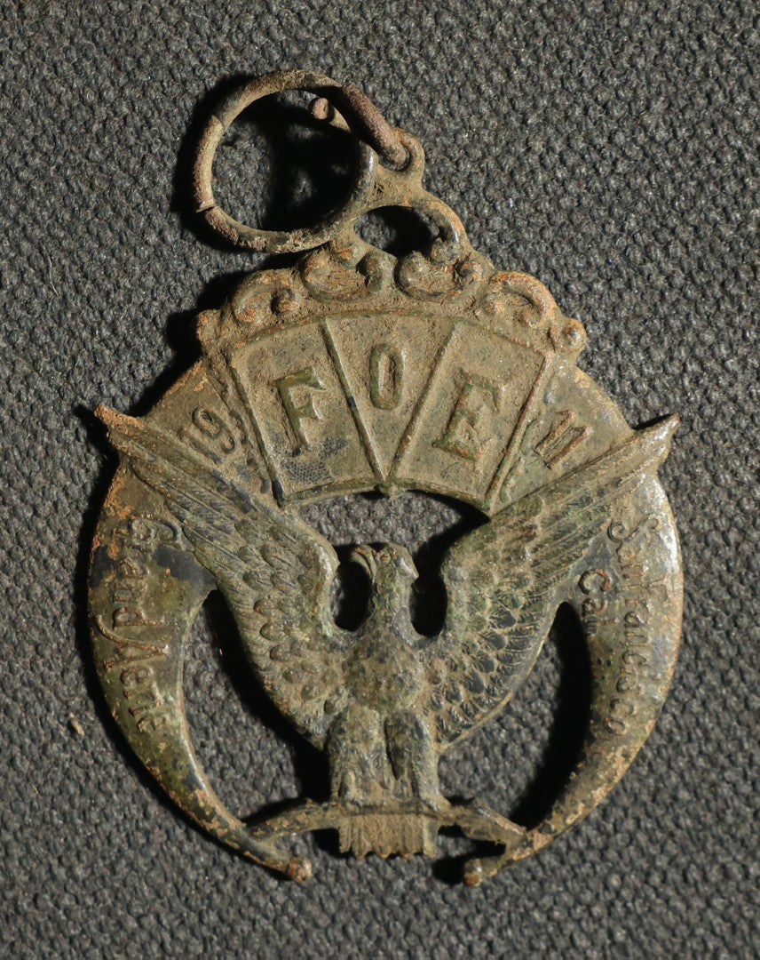 Four Pieces Including Federal Order of Eagles and Track Fobs, and Pair of Syracuse New York Centennial Coins