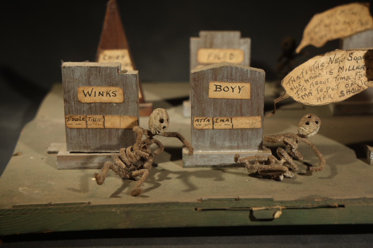 Antique Folk Art Handmade Graveyard Diorama with Wooden Gravestones, Twisted Pipe Cleaner Skeleton Figures, and Hand-Lettered Speech Bubbles, "The Grove Ghosts Inc Knights of Fun"