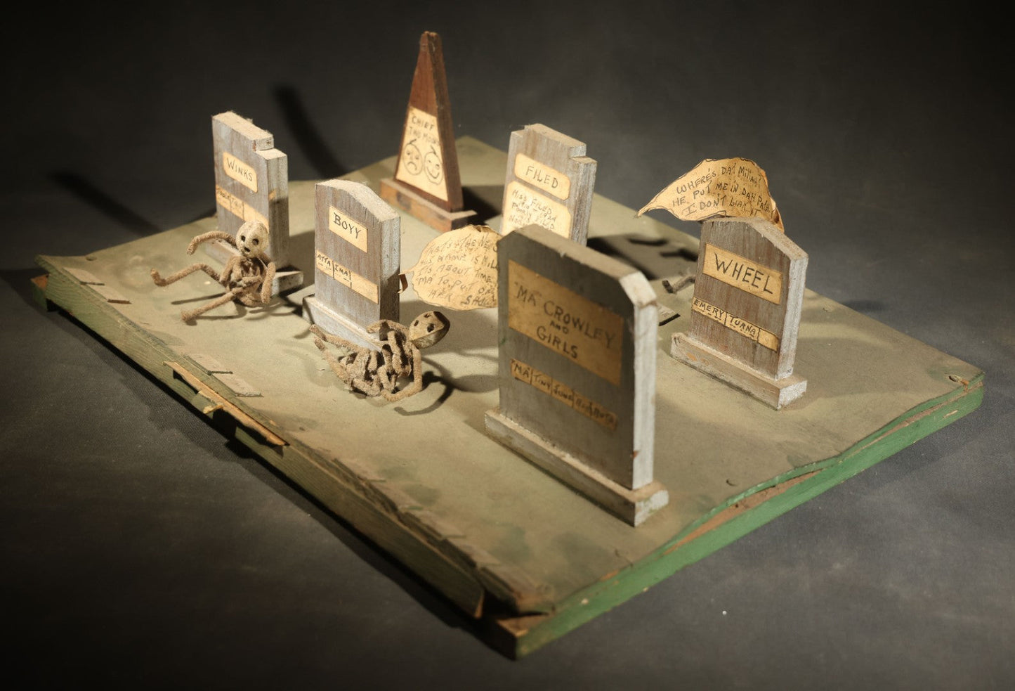 Antique Folk Art Handmade Graveyard Diorama with Wooden Gravestones, Twisted Pipe Cleaner Skeleton Figures, and Hand-Lettered Speech Bubbles, "The Grove Ghosts Inc Knights of Fun"