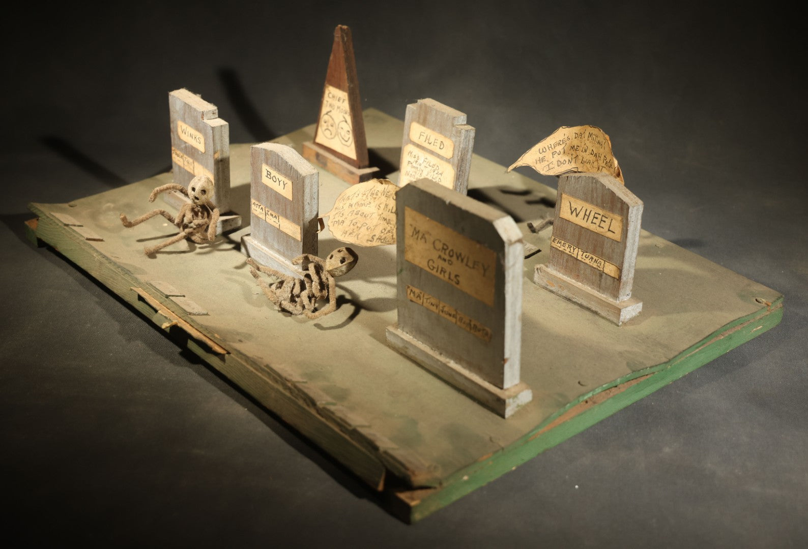 Antique Folk Art Handmade Graveyard Diorama with Wooden Gravestones, Twisted Pipe Cleaner Skeleton Figures, and Hand-Lettered Speech Bubbles, "The Grove Ghosts Inc Knights of Fun"