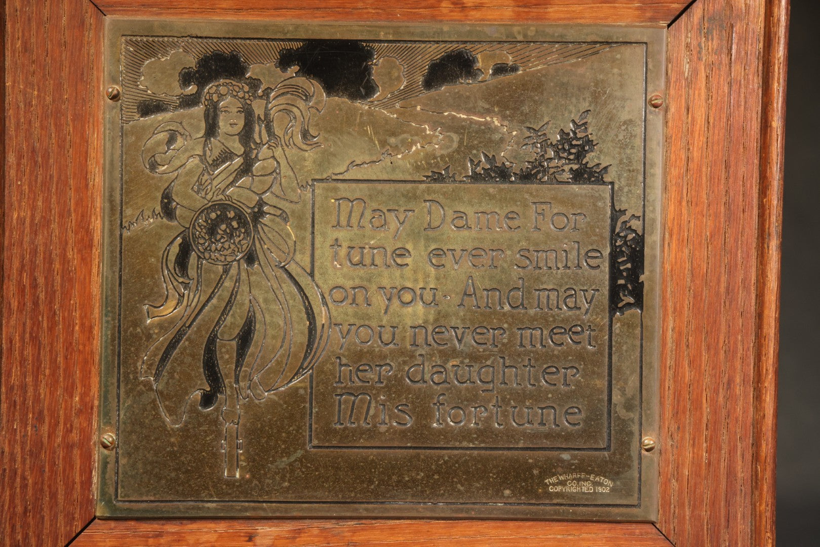 Antique Engraved Brass "Dame Fortune" Plaque in Oak Frame, Manufactured by The Wharff-Eaton Co. Inc., Copyrighted 1902