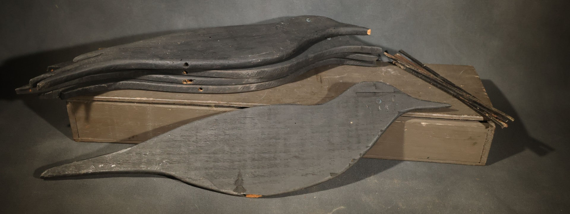 Grouping of Five Antique Black-Painted Flat Crow Silhouette Stick-Up Decoys with Support Poles in Wooden Storage Box