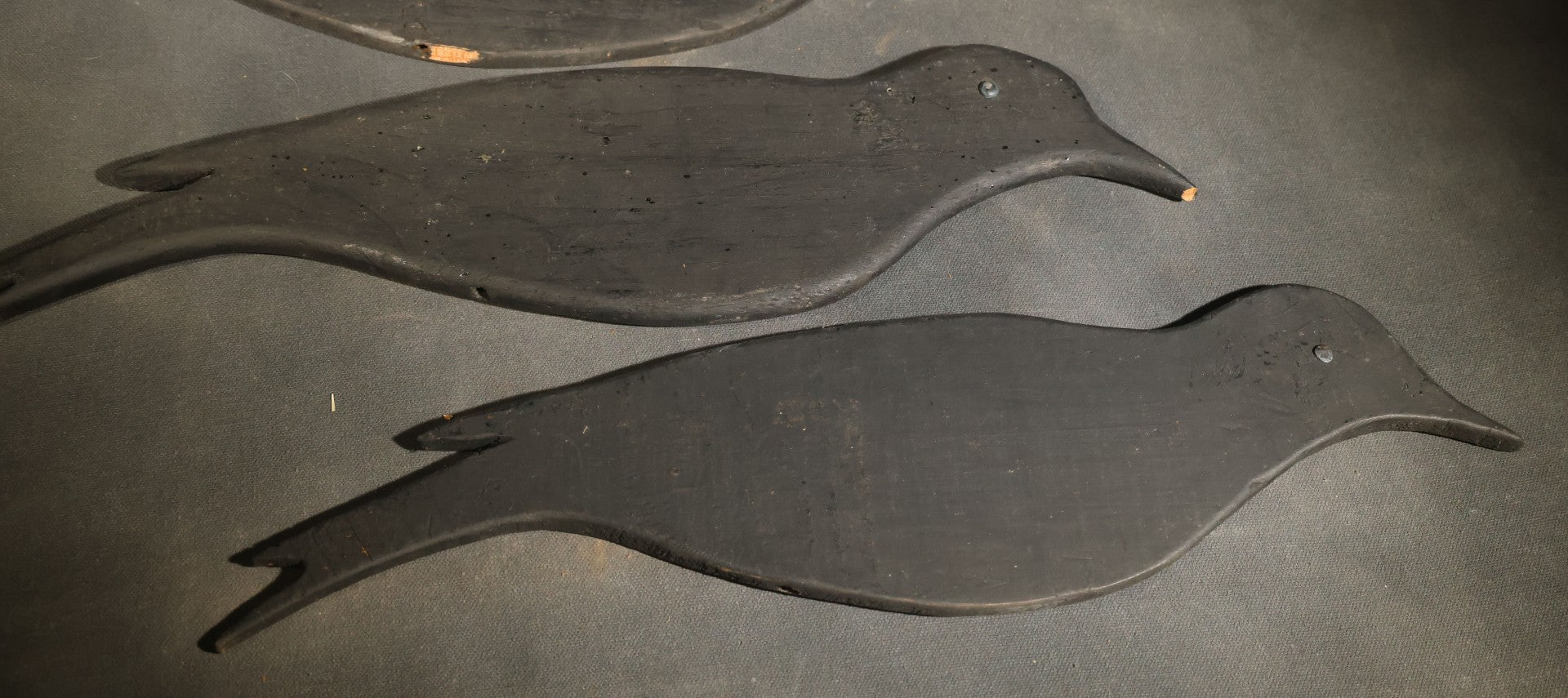 Grouping of Five Antique Black-Painted Flat Crow Silhouette Stick-Up Decoys with Support Poles in Wooden Storage Box