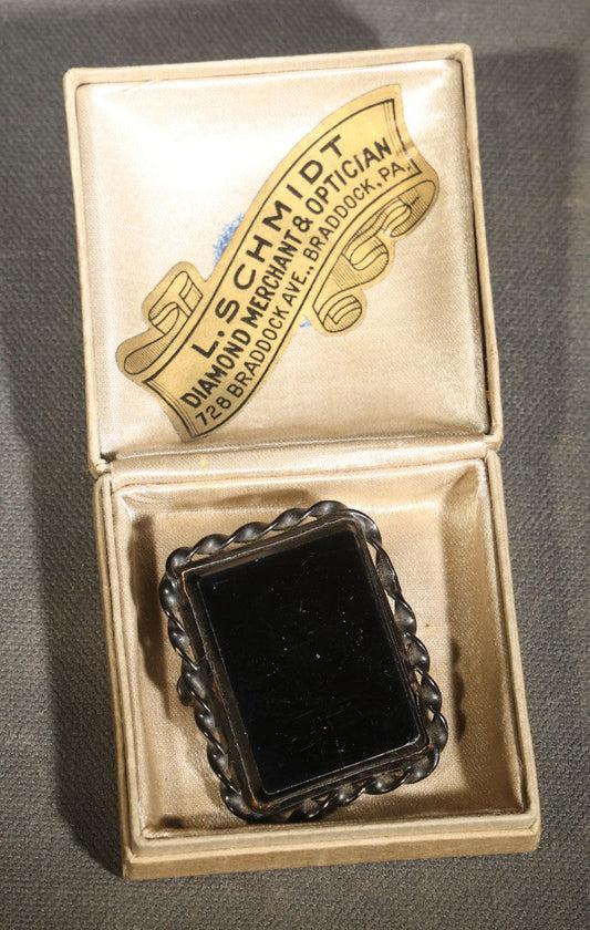 Antique Black Glass Mourning Brooch with Twisted Rope Border in L. Schmidt Diamond Merchant & Optician Jeweler's Box, Braddock, Pennsylvania