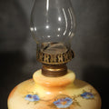 Lot 108 - Antique Hand-Painted Glass Oil Lamp with Blue Floral Decoration, Brass Burner, and Ornate Cast Metal Base, 15-1/2" H