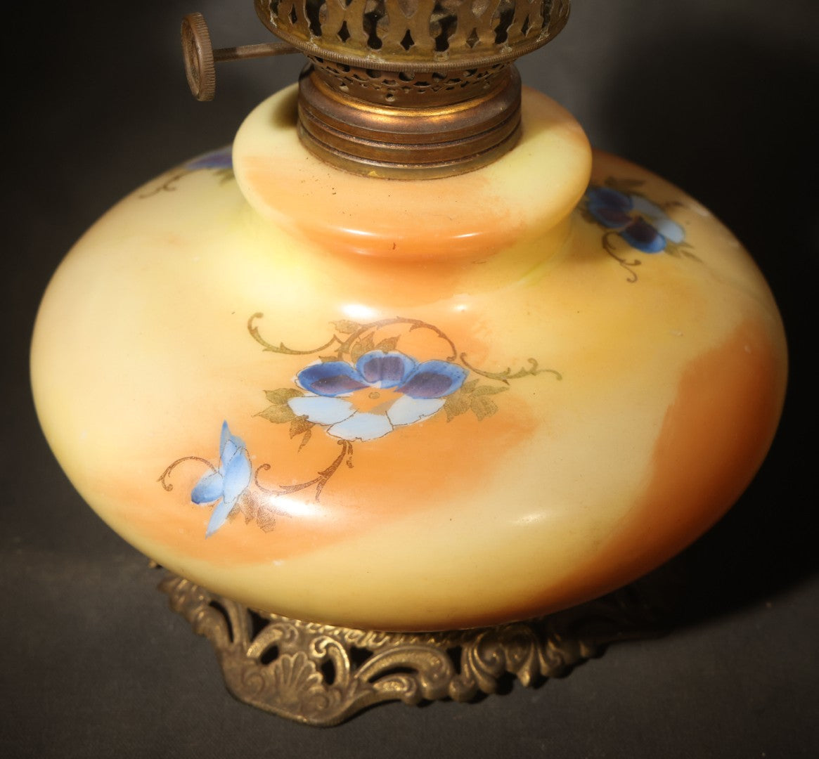Antique Hand-Painted Glass Oil Lamp with Blue Floral Decoration, Brass Burner, and Ornate Cast Metal Base