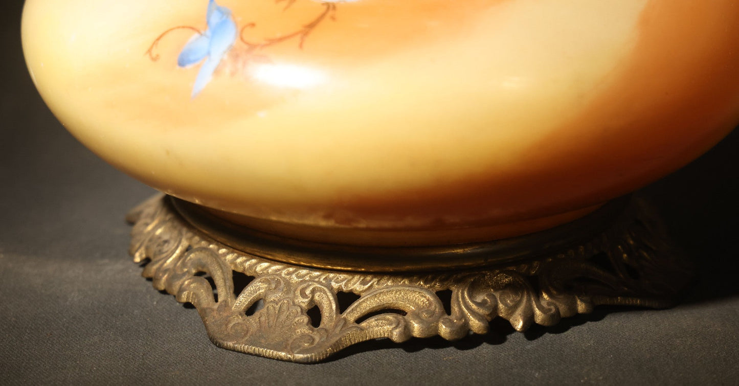 Antique Hand-Painted Glass Oil Lamp with Blue Floral Decoration, Brass Burner, and Ornate Cast Metal Base