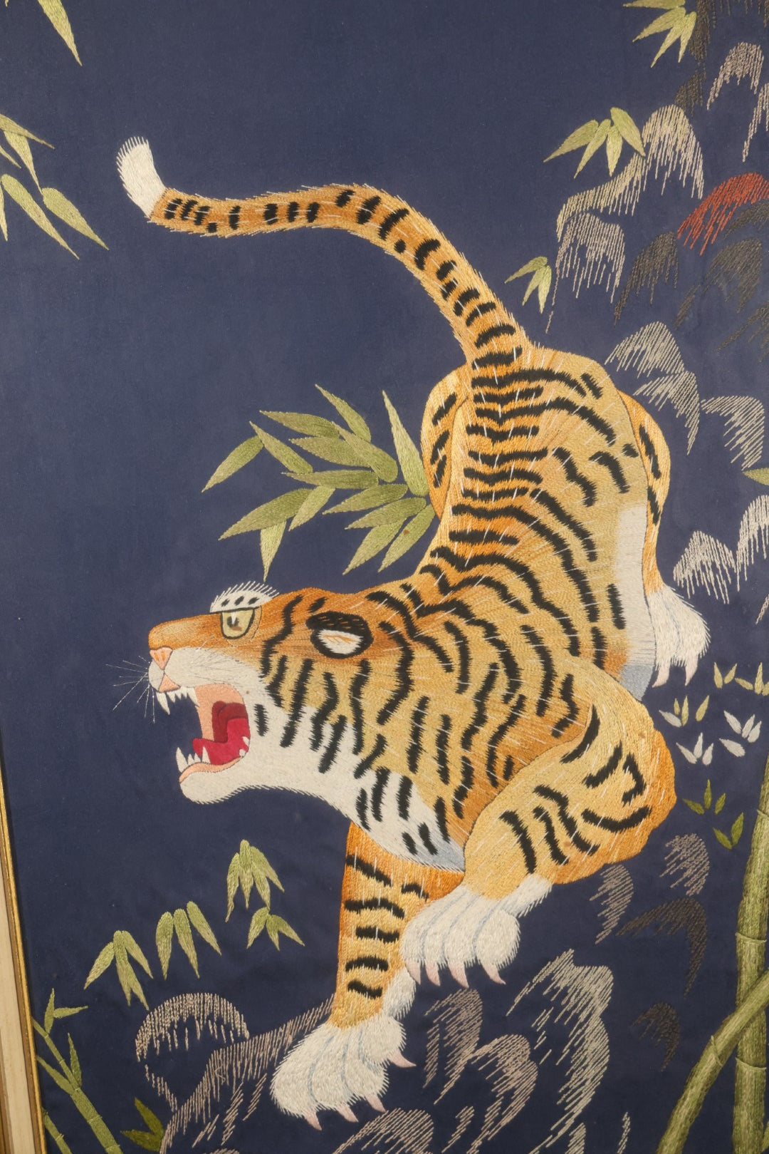 Vintage Framed Japanese Silk Embroidery of a Roaring Tiger Among Bamboo and Rocks on Navy Ground, Inscribed on Verso March 29, 1976