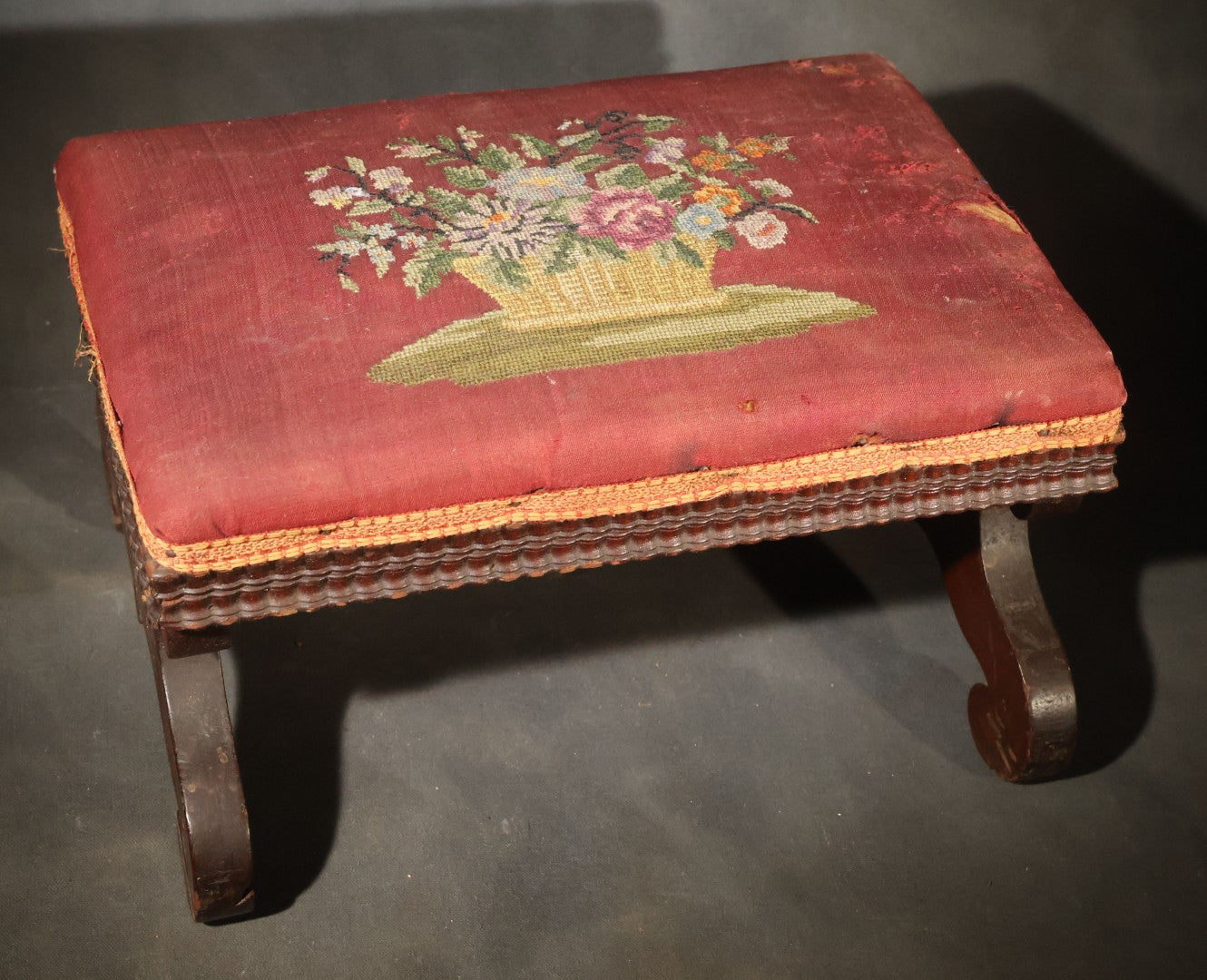 Antique Empire-Style Needlepoint Upholstered Footstool with Floral Basket Motif and Scrolled Legs