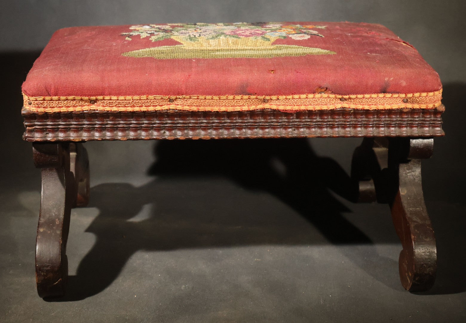 Antique Empire-Style Needlepoint Upholstered Footstool with Floral Basket Motif and Scrolled Legs