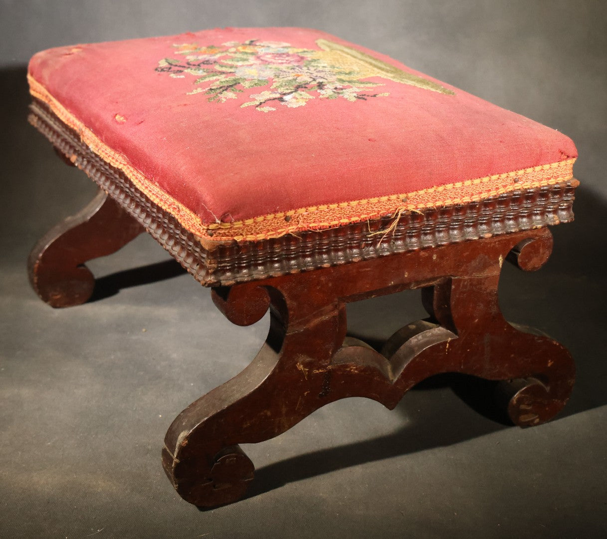 Antique Empire-Style Needlepoint Upholstered Footstool with Floral Basket Motif and Scrolled Legs