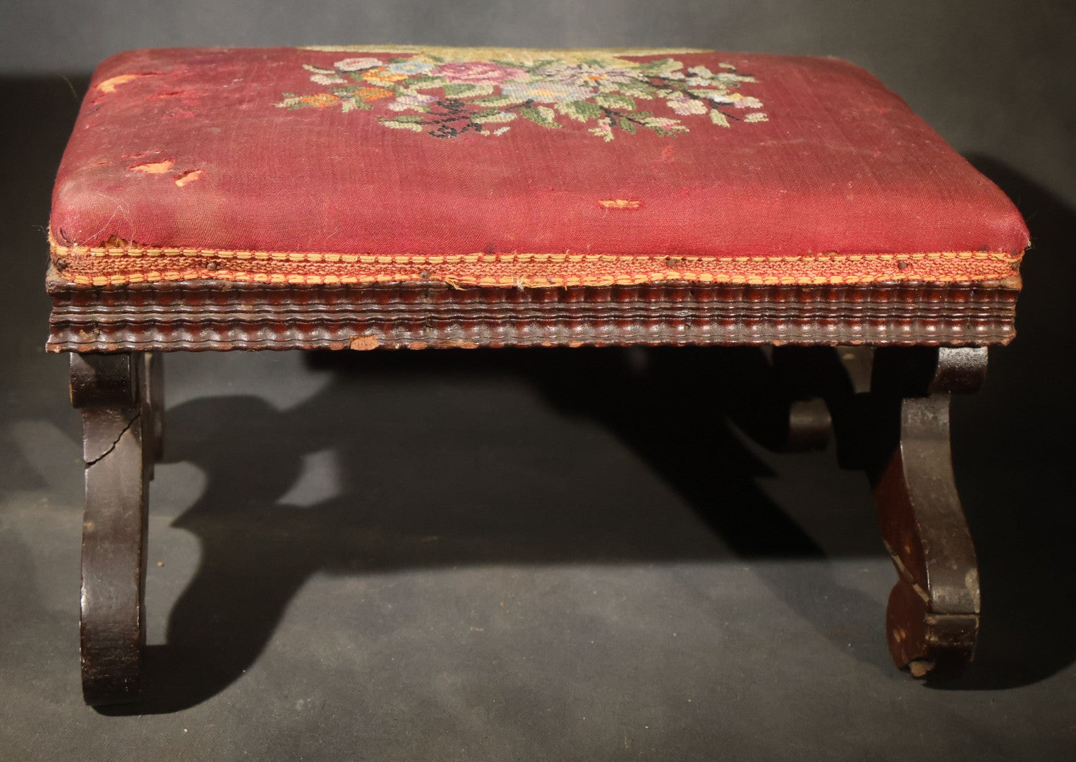 Antique Empire-Style Needlepoint Upholstered Footstool with Floral Basket Motif and Scrolled Legs