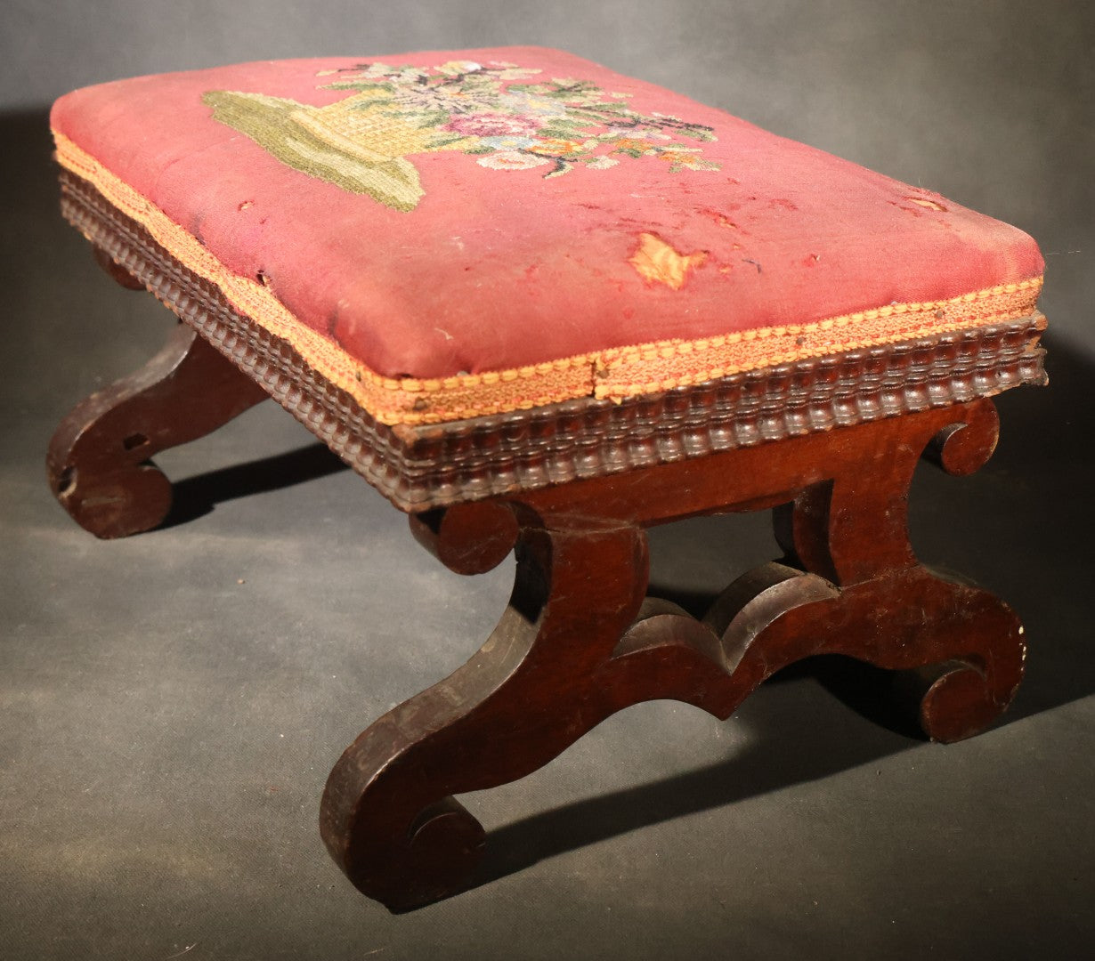 Antique Empire-Style Needlepoint Upholstered Footstool with Floral Basket Motif and Scrolled Legs