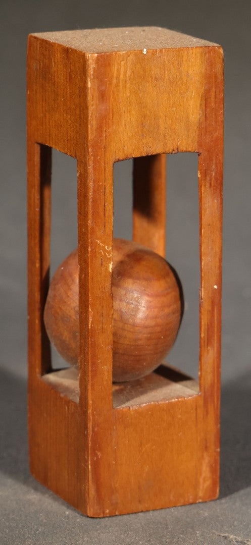 Grouping of Three Vintage Folk Art Wood Carvings including Ball-in-Cage Whimsy, Carved Face Block, and Carved Face on a Stick