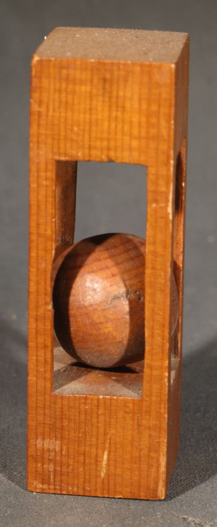Grouping of Three Vintage Folk Art Wood Carvings including Ball-in-Cage Whimsy, Carved Face Block, and Carved Face on a Stick