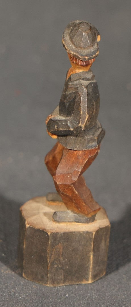 Trio of Antique Carved Wood Figures including a Penguin, a Painted Man in Cap and Jacket, and a Dark-Stained Anthropomorphic Figure