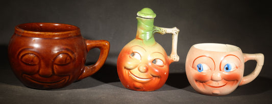 Trio of Vintage Figural Face Ceramics including Brown Glazed Smiley Mug, Anthropomorphic Tomato Jug with Lid, and Czechoslovakia Porcelanit Smiling Face Mug