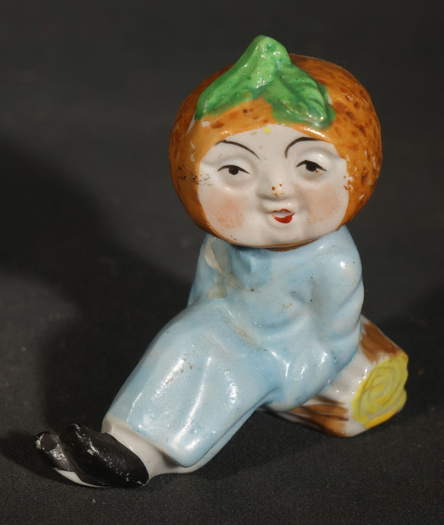 Trio of Vintage Porcelain Figurines including Clown with Violin, Open-Mouth Yawning Baby, and Orange-Head Child on Log