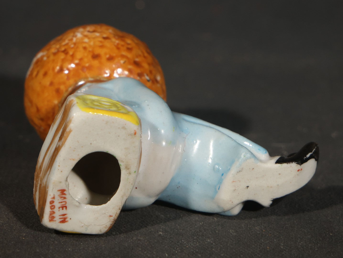 Trio of Vintage Porcelain Figurines including Clown with Violin, Open-Mouth Yawning Baby, and Orange-Head Child on Log