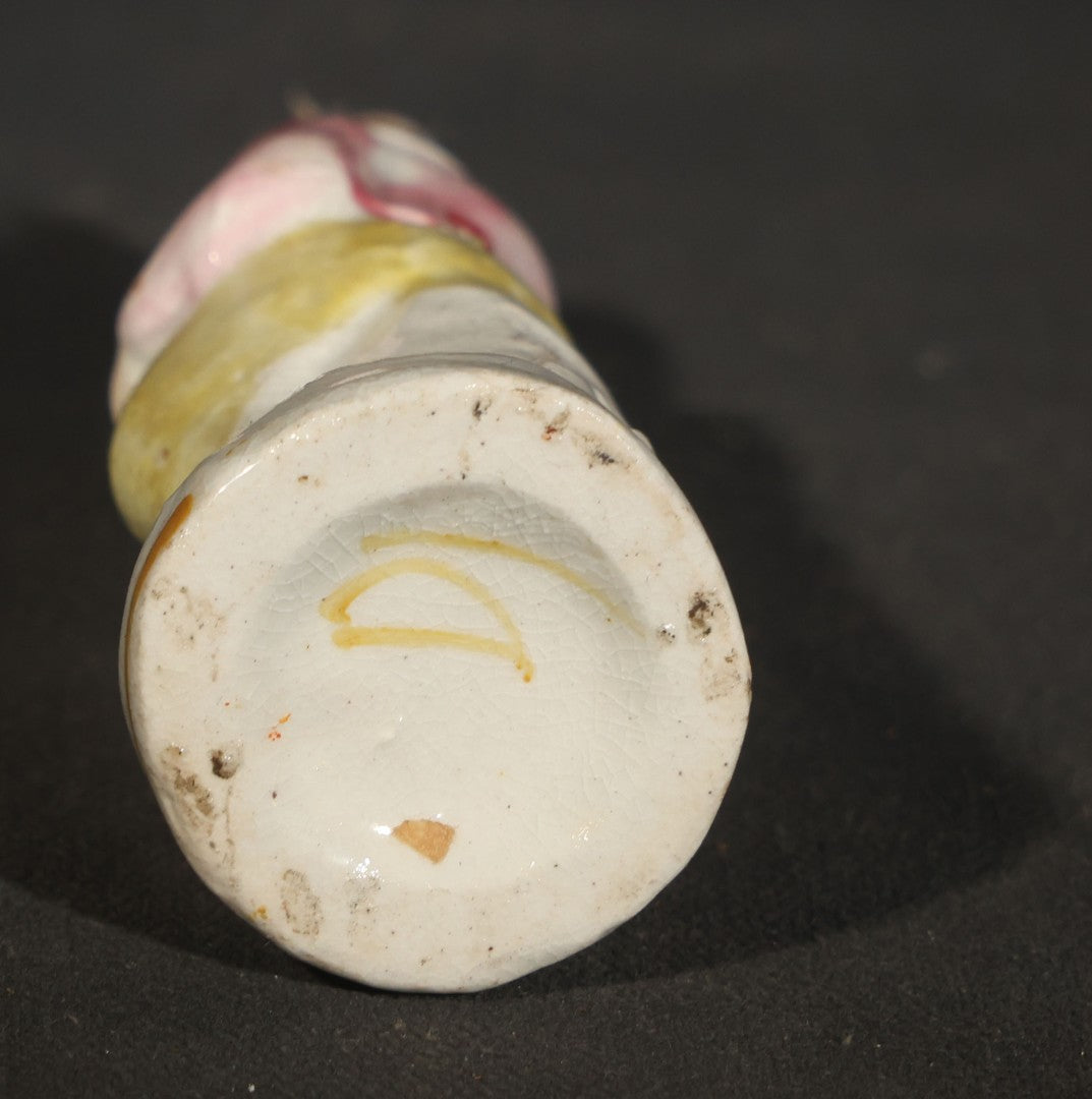 Trio of Vintage Porcelain Figurines including Clown with Violin, Open-Mouth Yawning Baby, and Orange-Head Child on Log