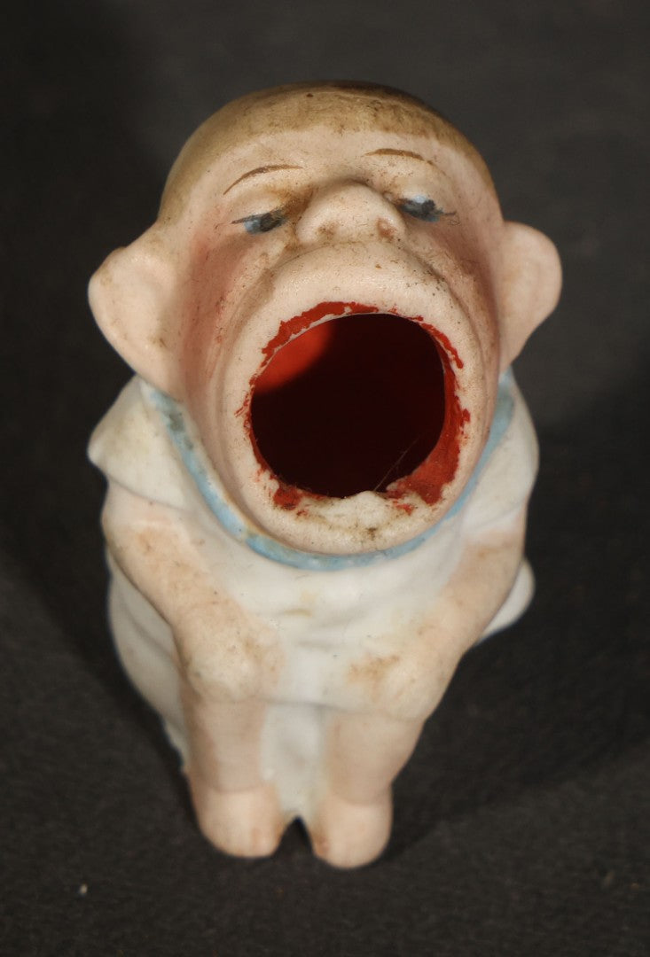 Trio of Vintage Porcelain Figurines including Clown with Violin, Open-Mouth Yawning Baby, and Orange-Head Child on Log
