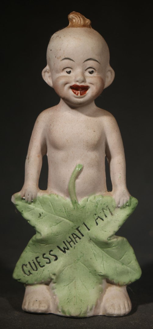 Antique German Bisque Figurine of a Baby Holding a Green Leaf Inscribed "Guess What I Am"