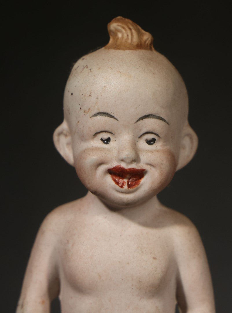 Antique German Bisque Figurine of a Baby Holding a Green Leaf Inscribed "Guess What I Am"