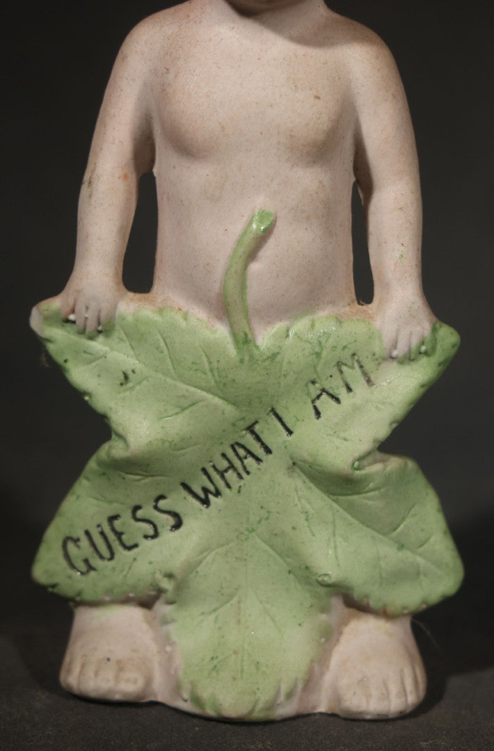 Antique German Bisque Figurine of a Baby Holding a Green Leaf Inscribed "Guess What I Am"