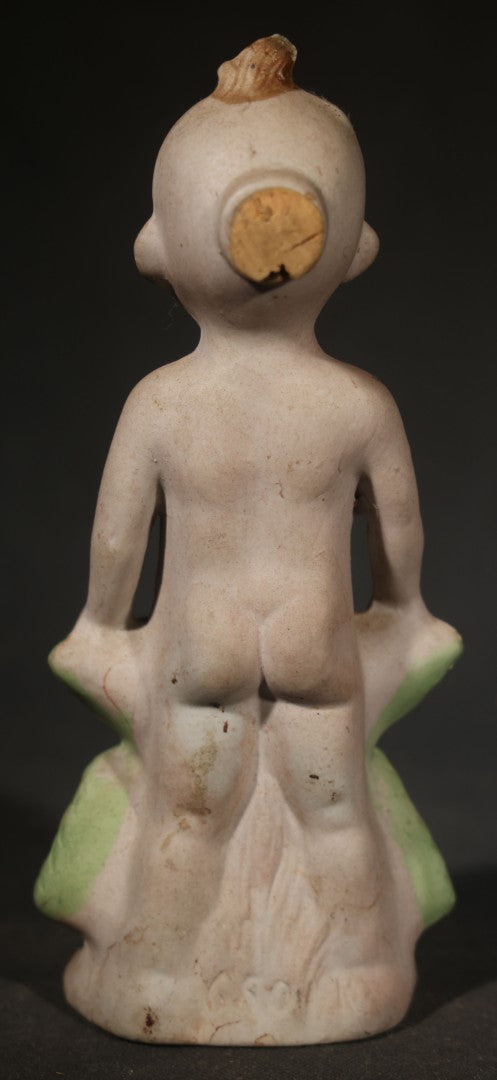 Antique German Bisque Figurine of a Baby Holding a Green Leaf Inscribed "Guess What I Am"
