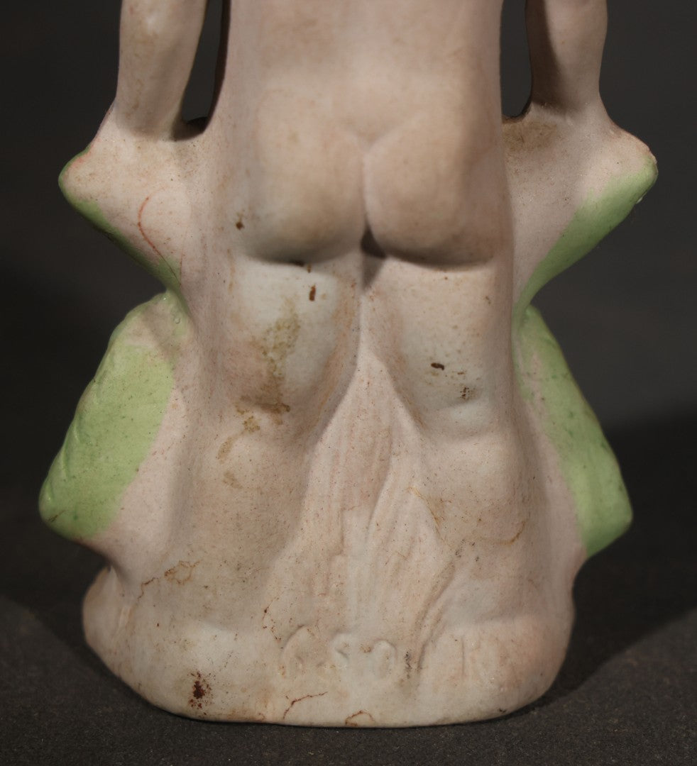 Antique German Bisque Figurine of a Baby Holding a Green Leaf Inscribed "Guess What I Am"