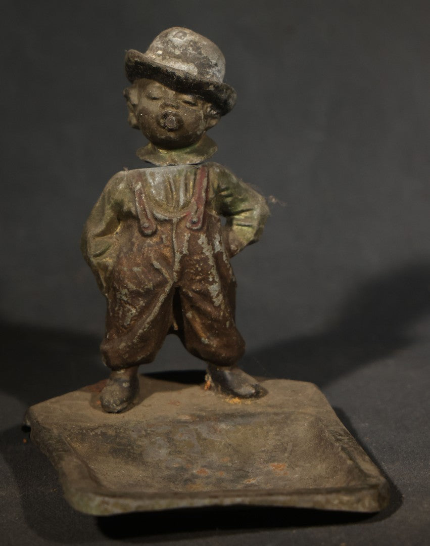 Antique Austrian Cold-Painted Metal Figural Nodder Ashtray Depicting a smoking Boy in Overalls and Hat, Marked Austria