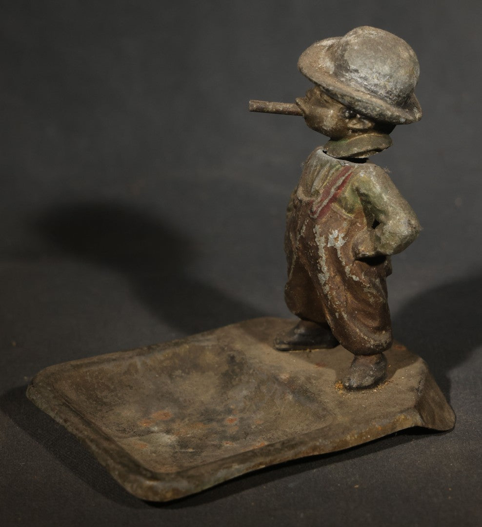 Antique Austrian Cold-Painted Metal Figural Nodder Ashtray Depicting a smoking Boy in Overalls and Hat, Marked Austria