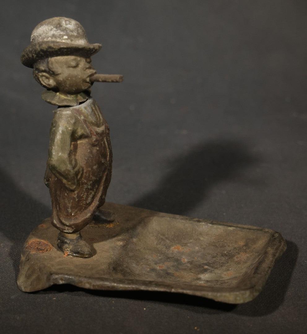 Antique Austrian Cold-Painted Metal Figural Nodder Ashtray Depicting a smoking Boy in Overalls and Hat, Marked Austria