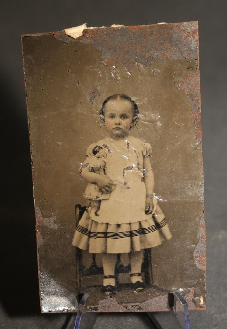 Pair of Antique Tintype Photographs of the Same Young Girl including One Holding a Doll