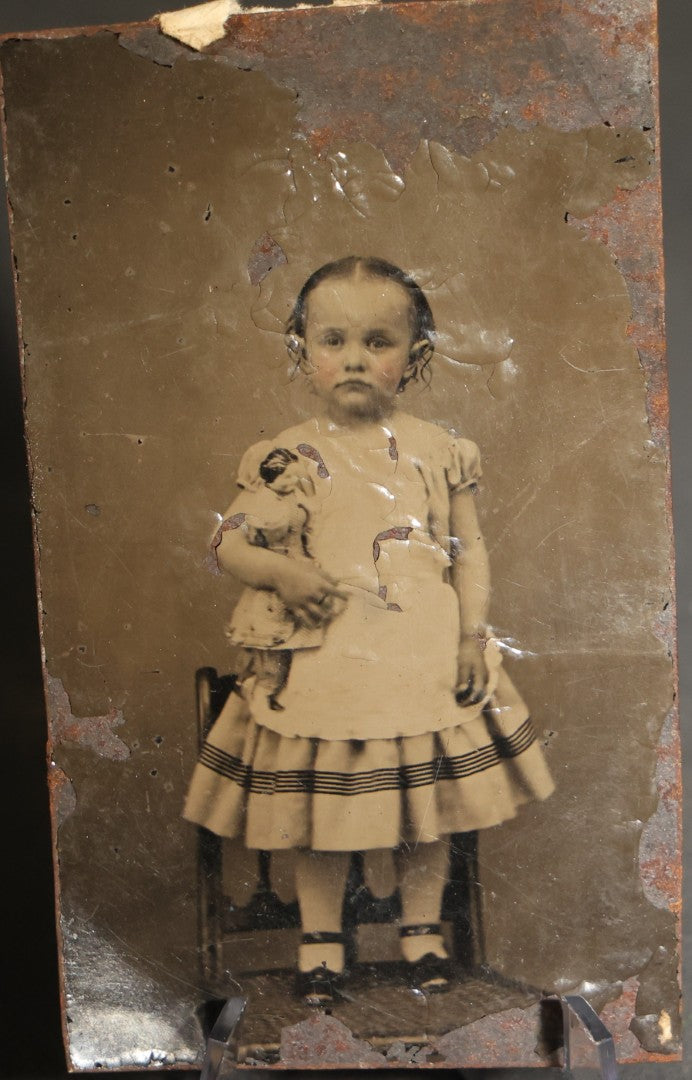 Pair of Antique Tintype Photographs of the Same Young Girl including One Holding a Doll