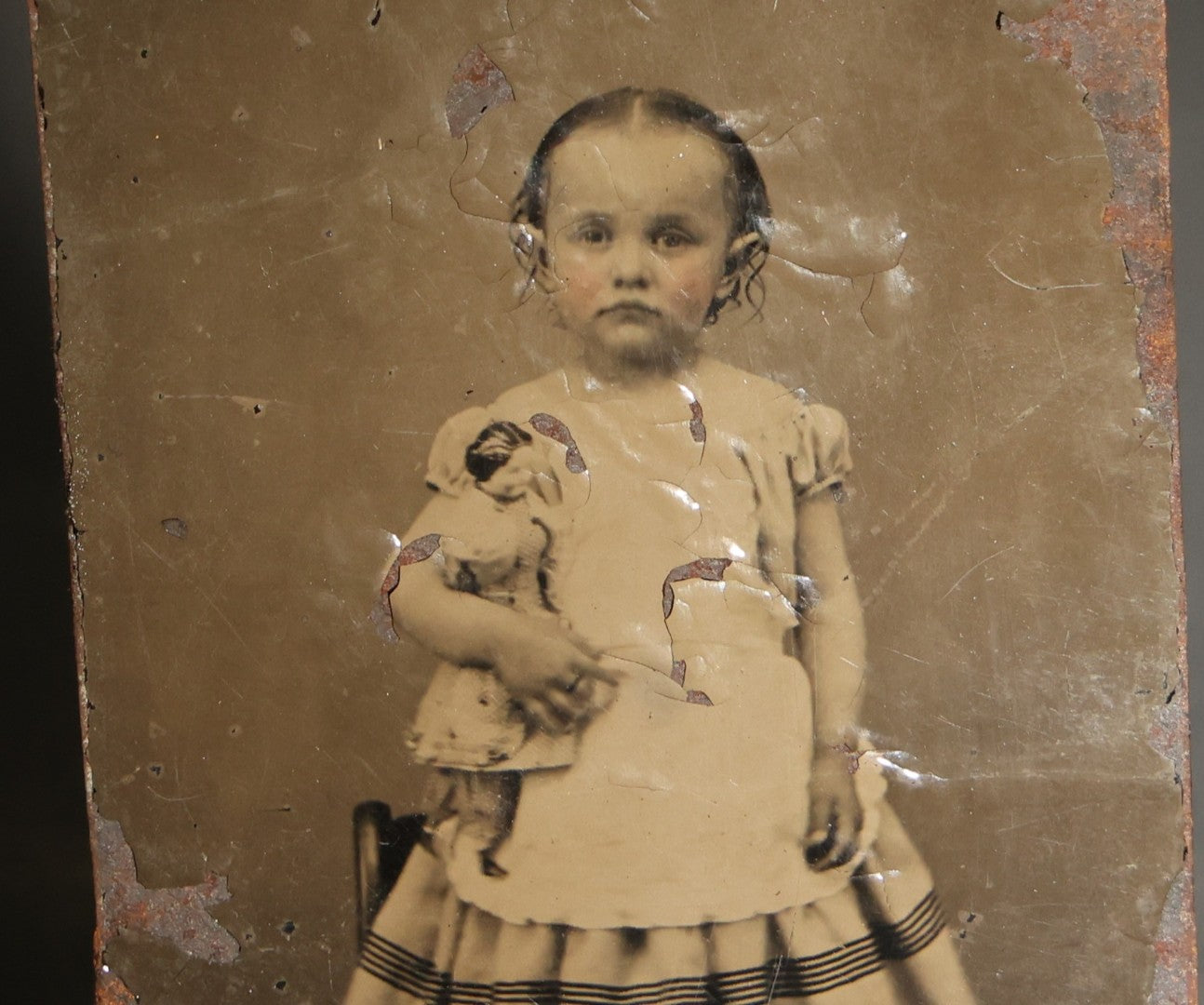 Pair of Antique Tintype Photographs of the Same Young Girl including One Holding a Doll