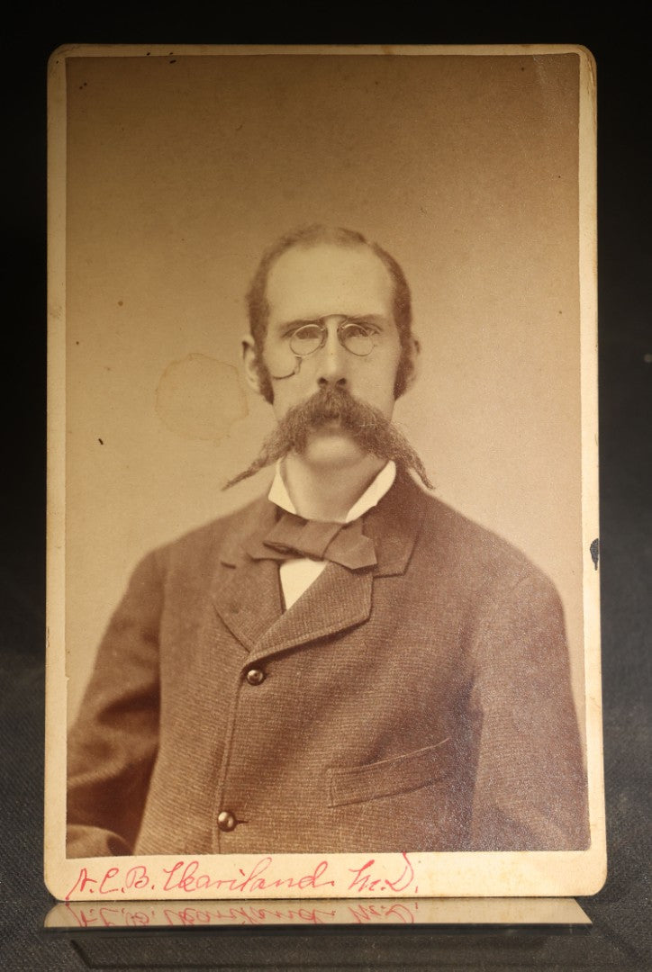 Grouping of Four Antique Photographs and Ephemera including Two Cabinet Card Photographs, a Board-Mounted Photograph of a House with Figures, and a Gibson Santa Claus Christmas Card