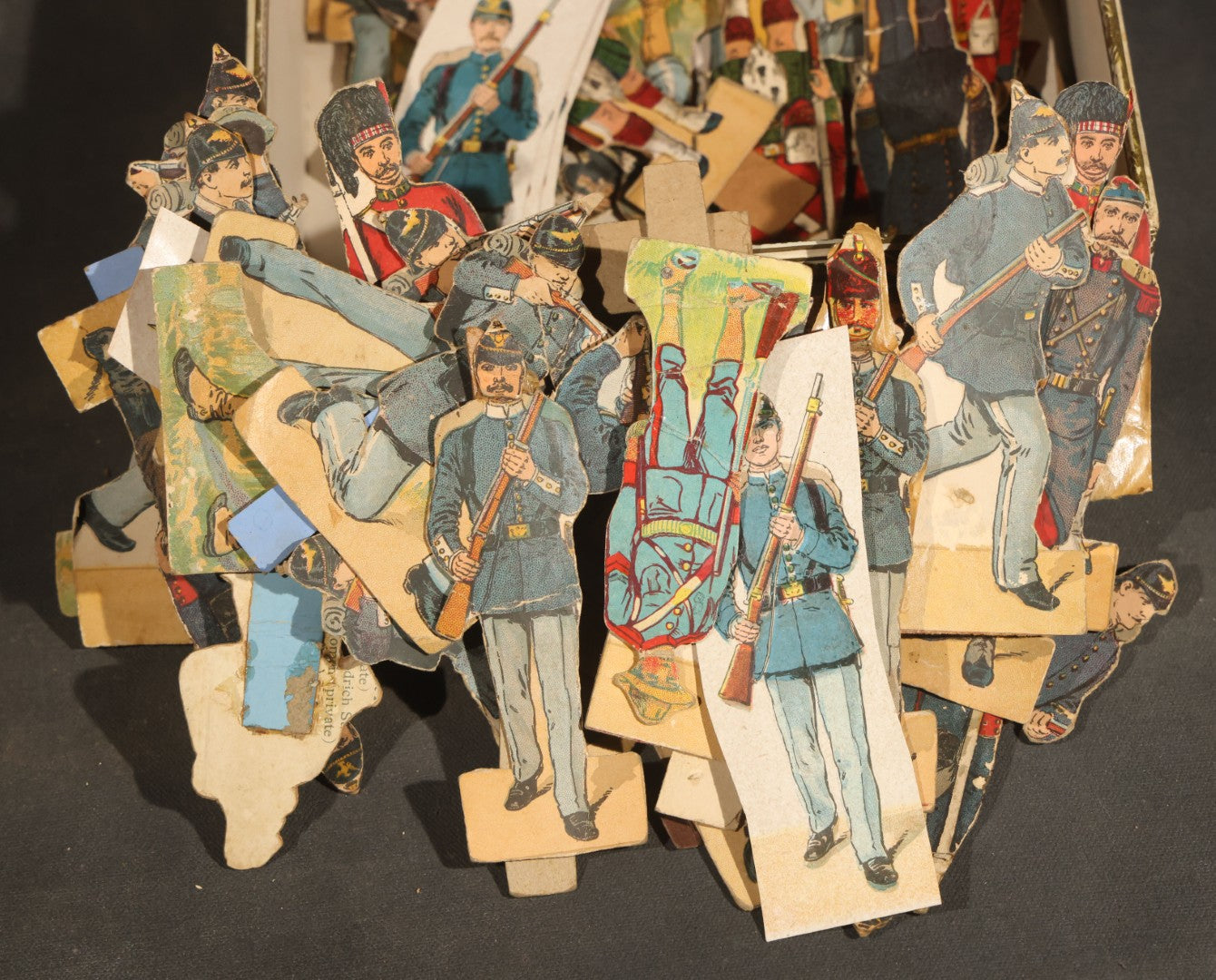 Grouping of Antique and Vintage Paper Soldiers and Military Figures including Chromolithograph Cutout Infantry and Cavalry, "Paper Soldiers of the American Revolution" Book, and Valiant Miniatures Metal Figure Kits