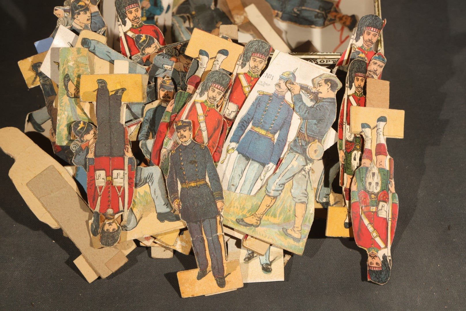 Grouping of Antique and Vintage Paper Soldiers and Military Figures including Chromolithograph Cutout Infantry and Cavalry, "Paper Soldiers of the American Revolution" Book, and Valiant Miniatures Metal Figure Kits