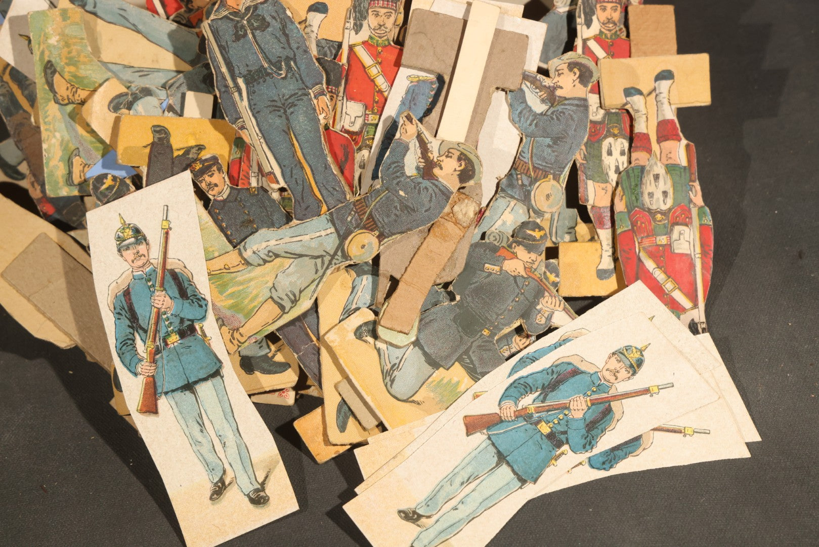 Grouping of Antique and Vintage Paper Soldiers and Military Figures including Chromolithograph Cutout Infantry and Cavalry, "Paper Soldiers of the American Revolution" Book, and Valiant Miniatures Metal Figure Kits
