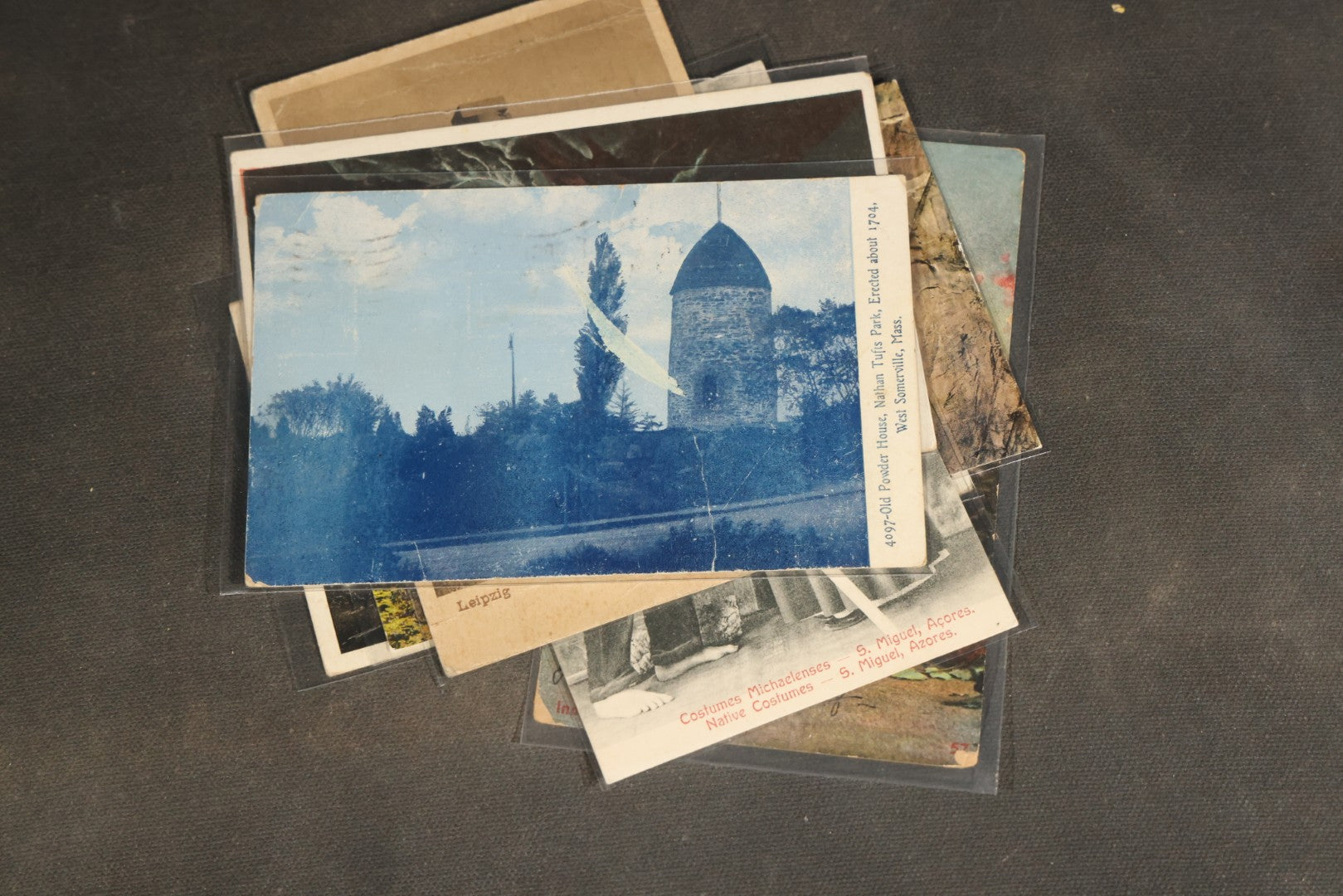 "Liza's Picks" Grouping of 30 Antique and Vintage Postcards including Massachusetts Map, Indian Sweetmeat Seller, Hebrew-Inscribed Cards, Castle Architecture, and Religious Subjects