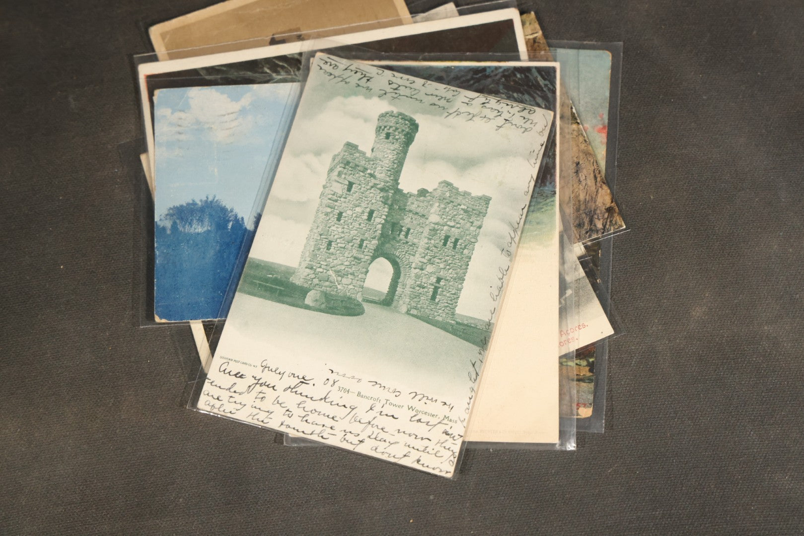 "Liza's Picks" Grouping of 30 Antique and Vintage Postcards including Massachusetts Map, Indian Sweetmeat Seller, Hebrew-Inscribed Cards, Castle Architecture, and Religious Subjects